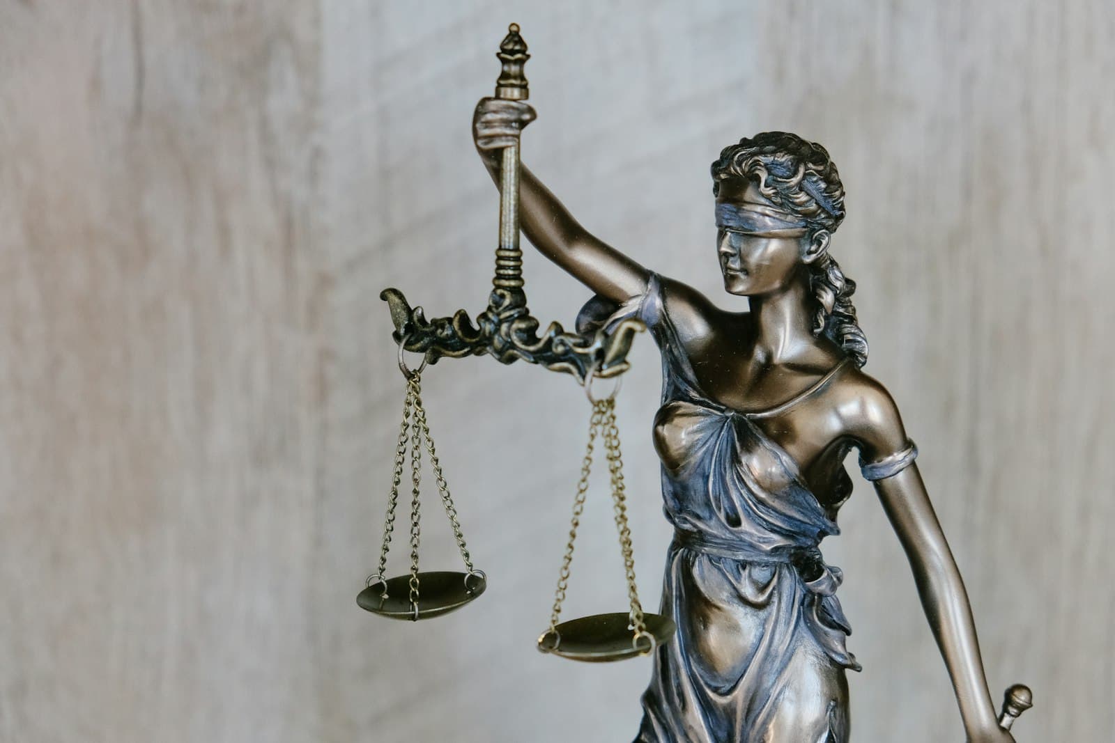 Law books and a gavel on a wooden desk