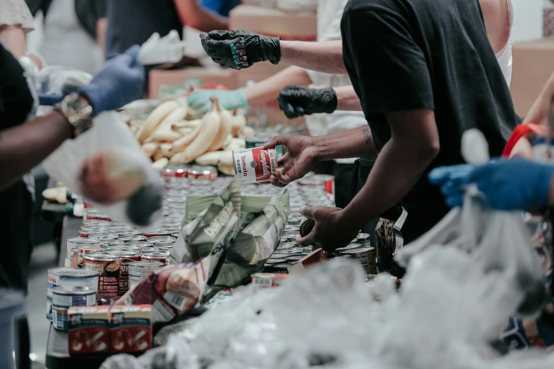 Volunteers packing donated goods at a community table