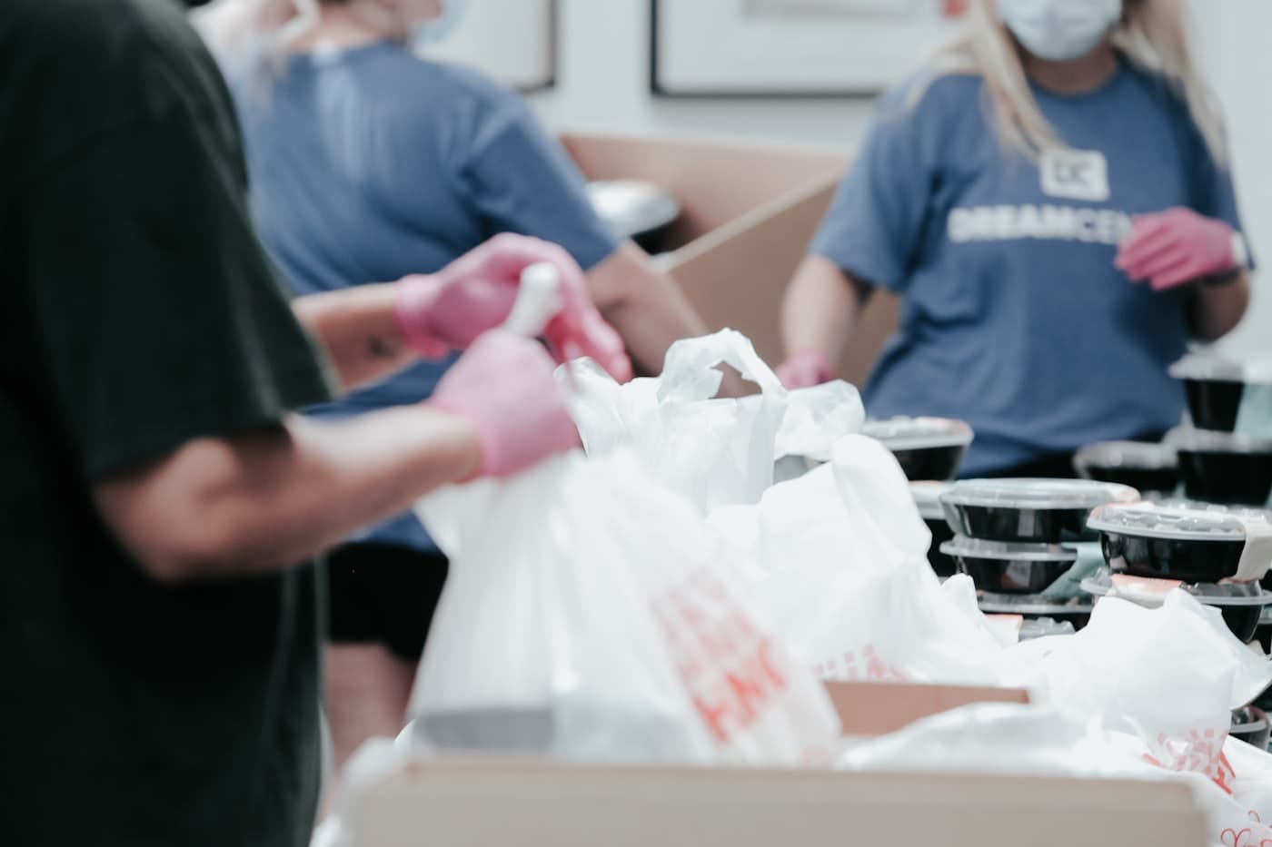 A volunteer packing food into bags for distribution