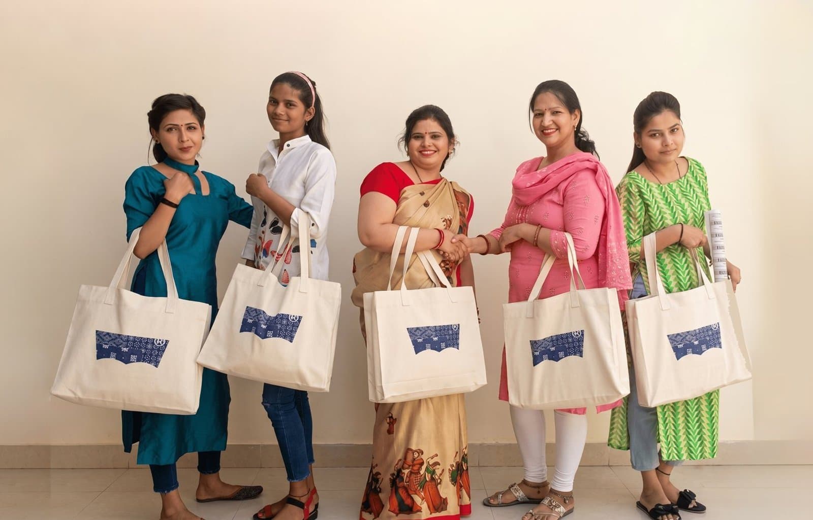 WORK+SHELTER team members with products made by the Delhi manufacturing operation